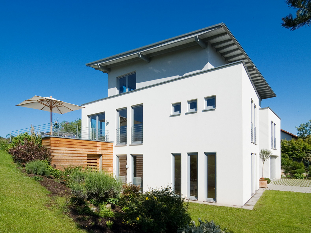 Einfamilienhaus mit vielen Fenstern und Garten
